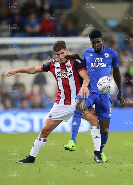 150817 - Cardiff City v Sheffield United, Sky Bet Championship - Bruno Ecuele Manga of Cardiff City and Ched Evans of Sheffield United compete for the ball
