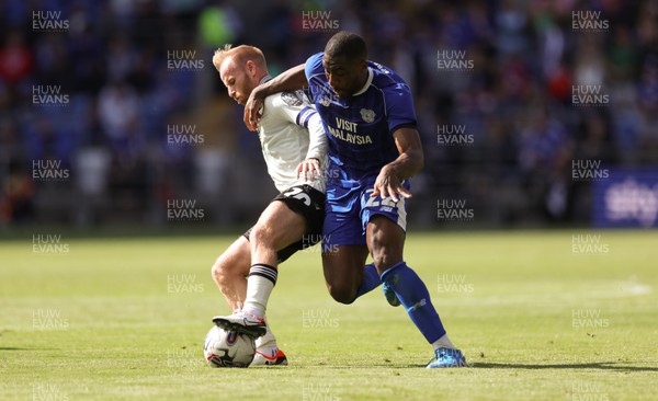 260823 - Cardiff City v Sheffield Wednesday, Sky Bet Championship - Yakou Meite of Cardiff City challenges Barry Bannan of Sheffield Wednesday