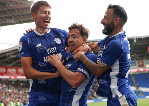 260823 - Cardiff City v Sheffield Wednesday, Sky Bet Championship - Ryan Wintle of Cardiff City celebrates along with Rubin Colwill of Cardiff City, left and Manolis Siopis of Cardiff City after he shoots to score from the penalty spot