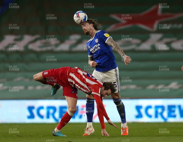 160321 Cardiff City v Stoke City, Sky Bet Championship - Aden Flint of Cardiff City heads the ball as he wins possession from Nick Powell of Stoke City