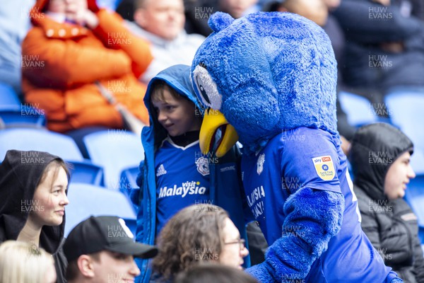 220423 - Cardiff City v Stoke City - Sky Bet Championship - Bartley the Bluebird takes a photo with a young fan