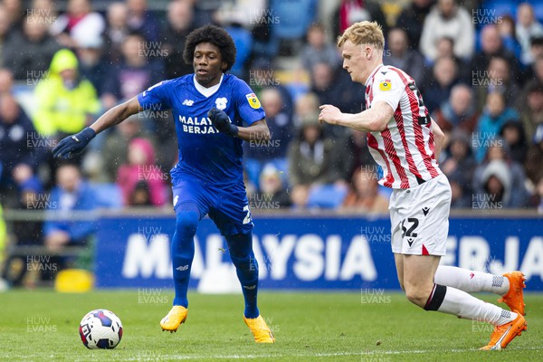 220423 - Cardiff City v Stoke City - Sky Bet Championship - Jaden Philogene-Bidace of Cardiff City in action against Connor Taylor of Stoke City