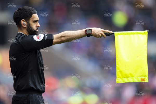 220423 - Cardiff City v Stoke City - Sky Bet Championship - Assistant Referee Bhupinder Singh Gill flags for offside 