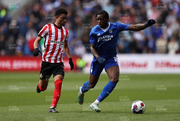 100423 - Cardiff City v Sunderland - SkyBet Championship - Sheyi Ojo of Cardiff City is challenged by Amad Diallo of Sunderland 