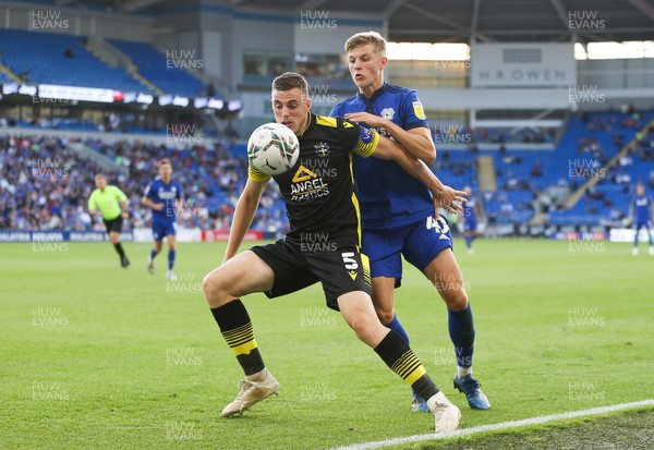 100821 - Cardiff City v Sutton United, EFL Carabao Cup - Ben Goodliffe of Sutton United and Thomas Davies of Cardiff City compete for the ball