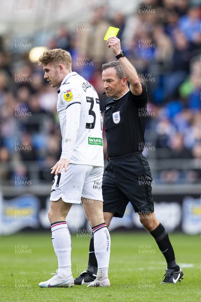 010423 - Cardiff City v Swansea City - Sky Bet Championship - Match Referee Keith Stroud shows a yellow card to Ollie Cooper of Swansea City