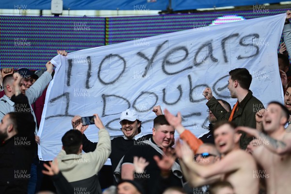 020422 - Cardiff City v Swansea City - Sky Bet Championship - Fans of Swansea City celebrate in front of a banner saying 110 years 1 double - SCFC