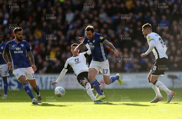120120 - Cardiff City v Swansea City - SkyBet Championship - Bersant Celina of Swansea City is tackled by Lee Tomlin of Cardiff City
