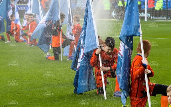 120120 - Cardiff City v Swansea City, Sky Bet Championship - The flag bearers get soaked by the water sprinklers at the start of the match