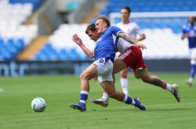 080826 - Cardiff City v Swindon Town, EFL Carabao Cup - Isaak Davies of Cardiff City and Mitchell Clark of Swindon Town compete for the ball