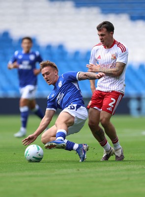 080826 - Cardiff City v Swindon Town, EFL Carabao Cup - Isaak Davies of Cardiff City and Mitchell Clark of Swindon Town compete for the ball