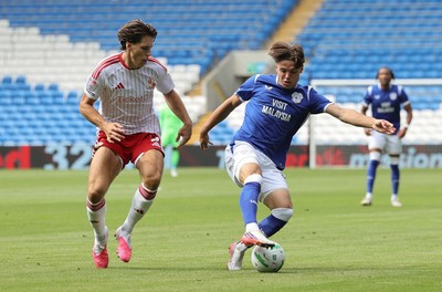 080826 - Cardiff City v Swindon Town, EFL Carabao Cup - Cian Ashford of Cardiff City holds off Stephan Negru of Swindon Town