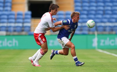 080826 - Cardiff City v Swindon Town, EFL Carabao Cup - Isaak Davies of Cardiff City and Stephan Negru of Swindon Town compete for the ball