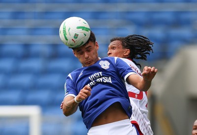 080826 - Cardiff City v Swindon Town, EFL Carabao Cup - Alex Robertson of Cardiff City heads the ball forward