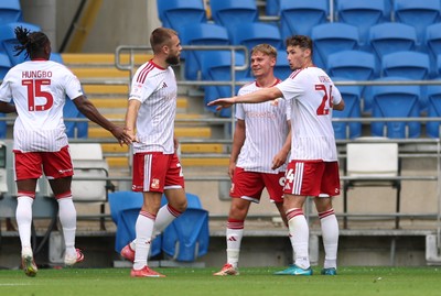 080826 - Cardiff City v Swindon Town, EFL Carabao Cup - Paul Glatzel of Swindon Town, centre, is congratulated after he scores the second goal