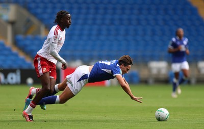 080826 - Cardiff City v Swindon Town, EFL Carabao Cup - Joel Colwill of Cardiff City is brought down by James Debayo of Swindon Town