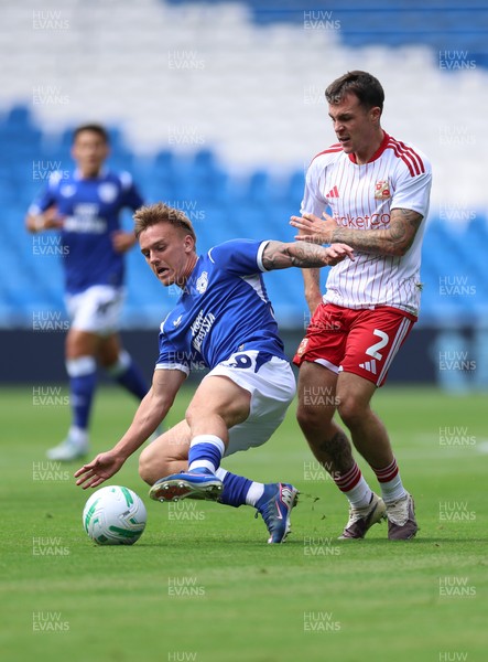 080826 - Cardiff City v Swindon Town, EFL Carabao Cup - Isaak Davies of Cardiff City and Mitchell Clark of Swindon Town compete for the ball