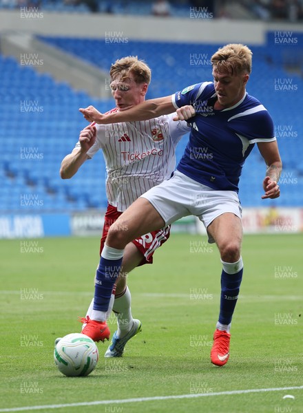 080826 - Cardiff City v Swindon Town, EFL Carabao Cup - Joel Bagan of Cardiff City holds off Sam Inwood of Swindon Town