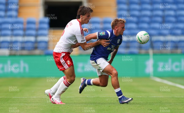 080826 - Cardiff City v Swindon Town, EFL Carabao Cup - Isaak Davies of Cardiff City and Stephan Negru of Swindon Town compete for the ball