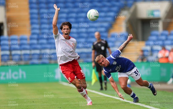 080826 - Cardiff City v Swindon Town, EFL Carabao Cup - Isaak Davies of Cardiff City and Stephan Negru of Swindon Town compete for the ball