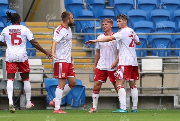 080826 - Cardiff City v Swindon Town, EFL Carabao Cup - Paul Glatzel of Swindon Town, centre, is congratulated after he scores the second goal