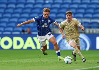 120825 - Cardiff City v Swindon Town, EFL Carabao Cup, Round 1 - Gavin Kilkenny of Swindon Town holds off Isaak Davies of Cardiff City