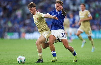 120825 - Cardiff City v Swindon Town, EFL Carabao Cup, Round 1 - Isaak Davies of Cardiff City and Joel McGregor of Swindon Town compete for the ball