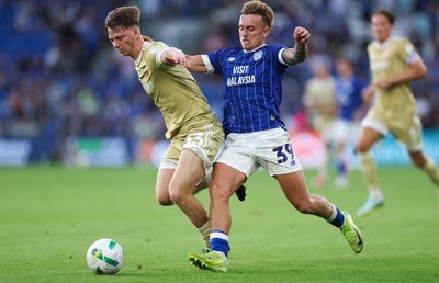 120825 - Cardiff City v Swindon Town, EFL Carabao Cup, Round 1 - Isaak Davies of Cardiff City and Joel McGregor of Swindon Town compete for the ball