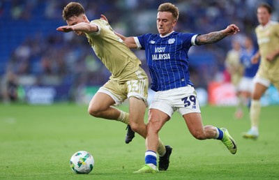 120825 - Cardiff City v Swindon Town, EFL Carabao Cup, Round 1 - Isaak Davies of Cardiff City and Joel McGregor of Swindon Town compete for the ball