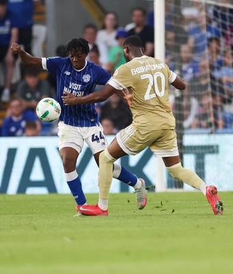 120825 - Cardiff City v Swindon Town, EFL Carabao Cup, Round 1 - Ronan Kpakio of Cardiff City and Princewill Ehibhationmham of Swindon Town compete for the ball