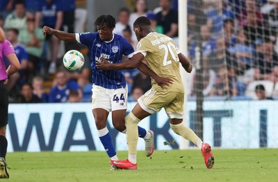 120825 - Cardiff City v Swindon Town, EFL Carabao Cup, Round 1 - Ronan Kpakio of Cardiff City and Princewill Ehibhationmham of Swindon Town compete for the ball