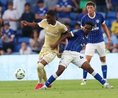 120825 - Cardiff City v Swindon Town, EFL Carabao Cup, Round 1 - Ronan Kpakio of Cardiff City and Princewill Ehibhationmham of Swindon Town compete for the ball