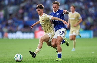 120825 - Cardiff City v Swindon Town, EFL Carabao Cup, Round 1 - Isaak Davies of Cardiff City and Joel McGregor of Swindon Town compete for the ball