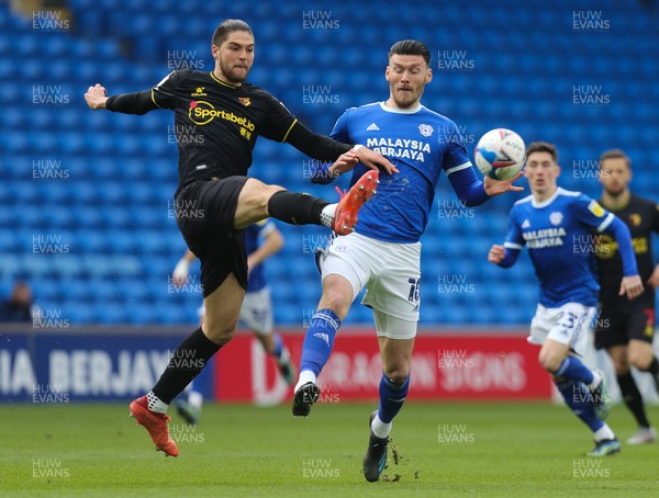 130321 Cardiff City v Watford, Sky Bet Championship - Francisco Sierralta of Watford and Kieffer Moore of Cardiff City compete for the ball