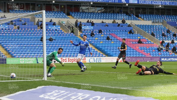 130321 Cardiff City v Watford, Sky Bet Championship - Francisco Sierralta of Watford puts the ball past his own goalkeeper Daniel Bachmann to score an own goal as Kieffer Moore of Cardiff City looks on