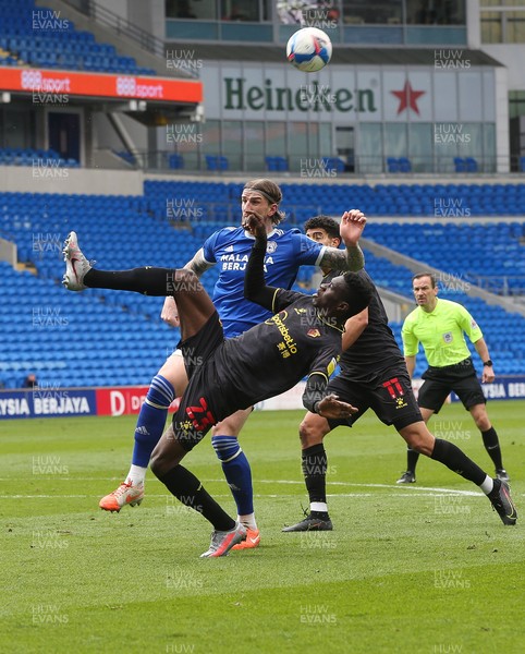 130321 Cardiff City v Watford, Sky Bet Championship - Ismaila Sarr of Watford clears the ball as Aden Flint of Cardiff City closes in