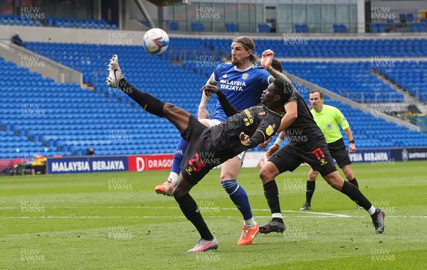 130321 Cardiff City v Watford, Sky Bet Championship - Ismaila Sarr of Watford clears the ball as Aden Flint of Cardiff City closes in