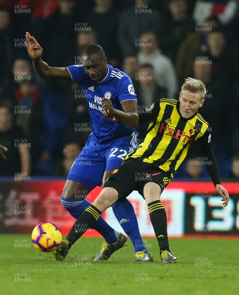 220219 - Cardiff City v Watford, Premier League - Sol Bamba of Cardiff City and Will Hughes of Watford compete for the ball