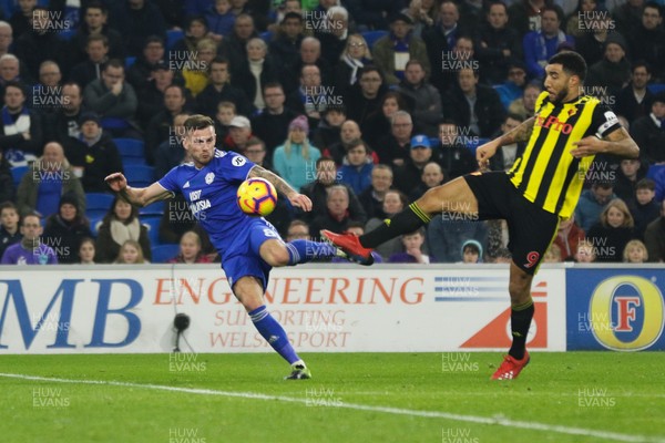 220219 - Cardiff City v Watford, Premier League - Joe Ralls of Cardiff City fires a shot at goal as Troy Deeney of Watford challenges