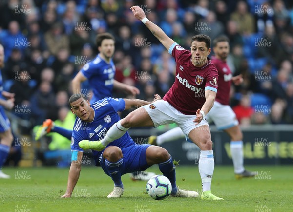 090319 - Cardiff City v West Ham United, Premier League - Lee Peltier of Cardiff City challenges Chicharito of West Ham United