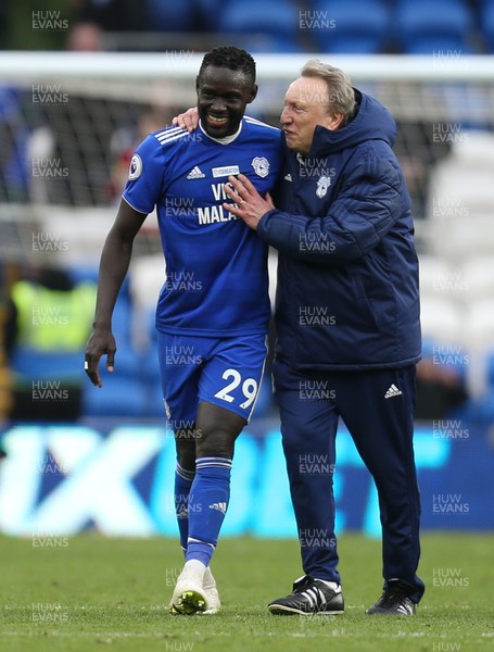 090319 - Cardiff City v West Ham United, Premier League - Cardiff City manager Neil Warnock celebrates with Oumar Niasse of Cardiff City at the end of the match