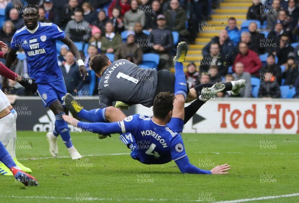 090319 - Cardiff City v West Ham United, Premier League - Sean Morrison of Cardiff City collides with West Ham United goalkeeper Lukasz Fabianski as he looks to shoot at goal