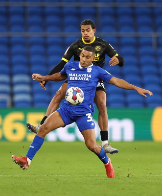 140123 - Cardiff City v Wigan Athletic, EFL Sky Bet Championship - Andy Rinomhota of Cardiff City is challenged by Miguel Azeez of Wigan Athletic