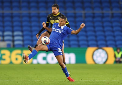 140123 - Cardiff City v Wigan Athletic, EFL Sky Bet Championship - Andy Rinomhota of Cardiff City is challenged by Miguel Azeez of Wigan Athletic