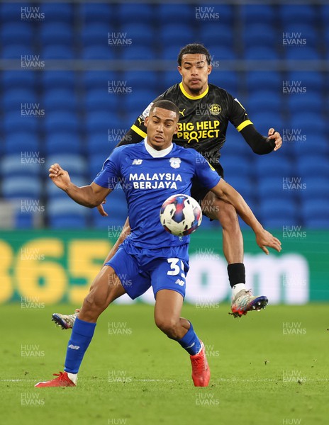 140123 - Cardiff City v Wigan Athletic, EFL Sky Bet Championship - Andy Rinomhota of Cardiff City is challenged by Miguel Azeez of Wigan Athletic