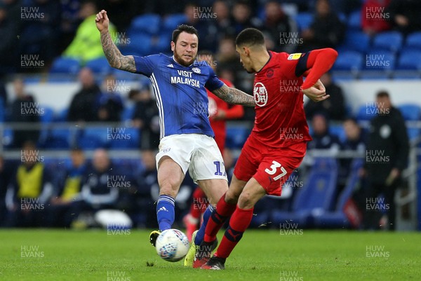 150220 - Cardiff City v Wigan Athletic - SkyBet Championship - Lee Tomlin of Cardiff City is tackled by Leon Balogun of Wigan