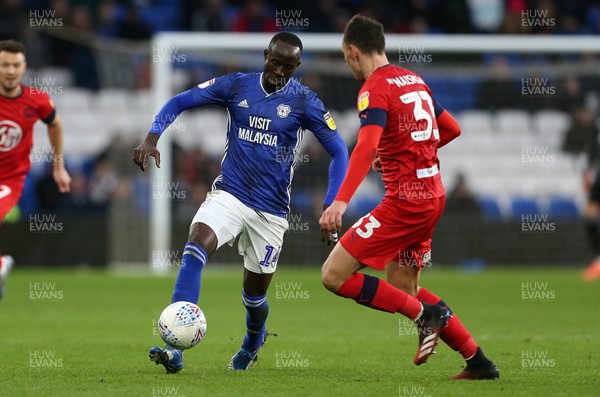150220 - Cardiff City v Wigan Athletic - SkyBet Championship - Albert Adomah of Cardiff City is tackled by Kal Naismith of Wigan