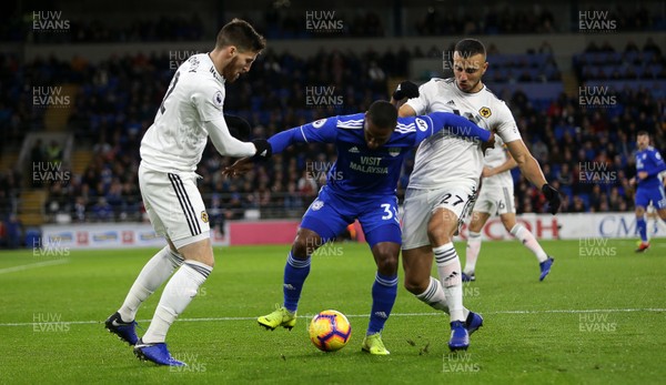 301118 - Cardiff City v Wolverhampton Wanderers - Premier League - Junior Hoilett of Cardiff City is tackled by Matt Doherty and Romain Saiss of Wolves