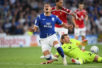 170826 - Cardiff City v Wrexham - Sky Bet Championship - Yousef Salech of Cardiff City is tackled by Anthony Patterson of Wrexham
