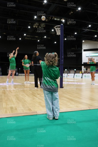 240525 - Cardiff Dragons v Loughborough Lightning - Netball Super League - A young fan watches the players warm up